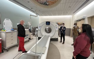 Alameda County Supervisor Lena Tam at San Leandro Hospital with Alameda Health System Staff viewing a CT scan machine during a tour.