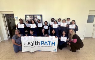 Healthpath students grop photo during stop the bleed training holding certificates.
