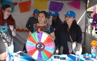 AHS staff tabling at Dia De Los Muertos event 2024.
