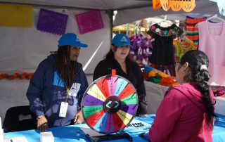 AHS staff tabling Dia De Los Muertos event 2024