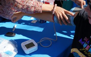 Blood pressure check at AHS tabling during Dia De Los Muertos event 2024.