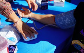 Blood pressure check at AHS tabling during Dia De Los Muertos event 2024.